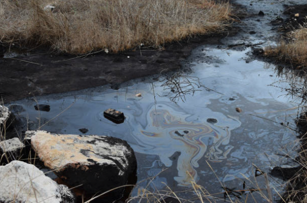 Oil spill contaminating the environment with hydrocarbons
