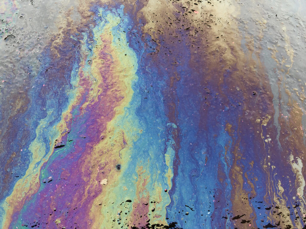 Eco concept, Oil spill on asphalt road